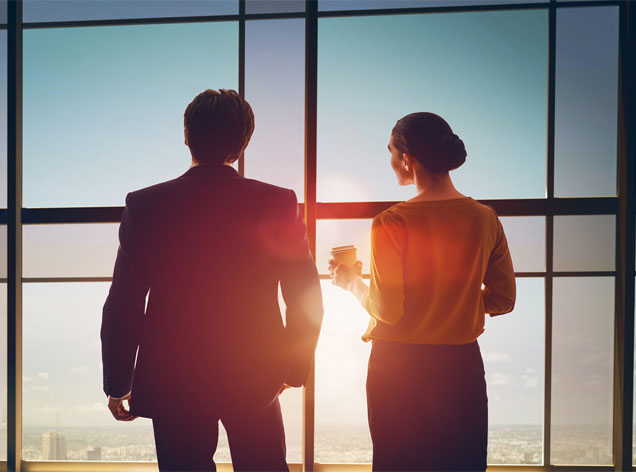 man and woman looking out window
